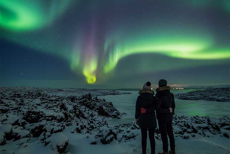 Couple Northern Lights watching in Straumsvík (The Lava Fields near Hafnarfjörður)