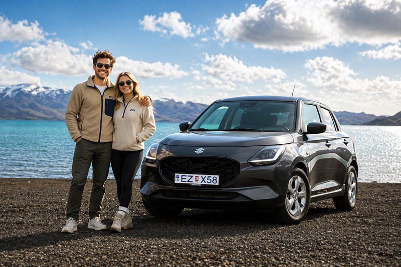 Couple next to a rental car on Iceland self drive adventure