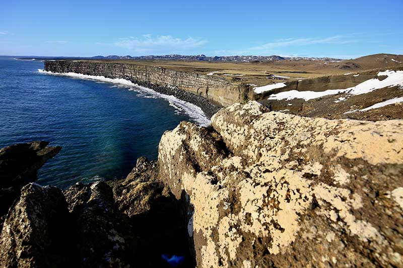 Aerial view of Krýsuvíkurbjarg Cliffs on Iceland’s Reykjanes Peninsula, showcasing dramatic sea cliffs and the North Atlantic Ocean.