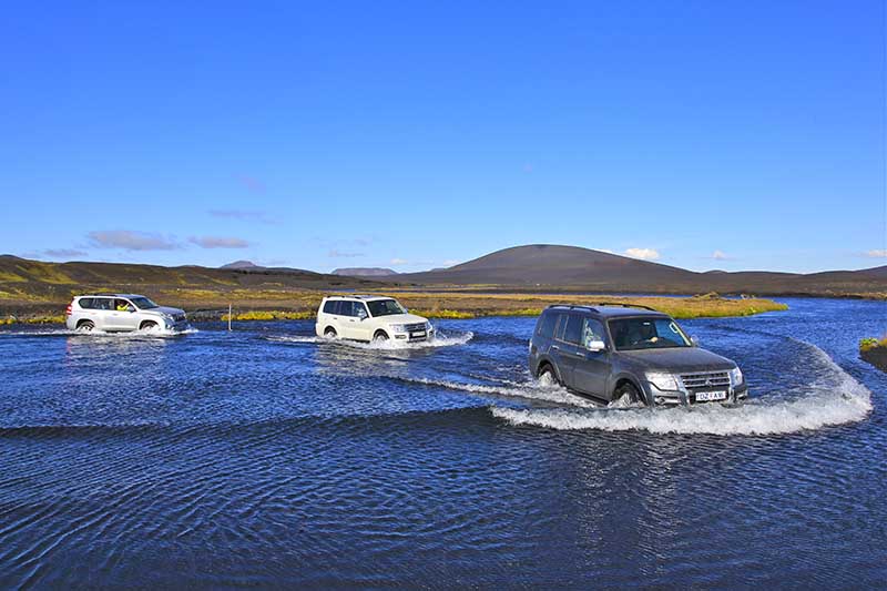 Cars crossing Lindá river en route to Askja in Iceland highlans self drive advnture
