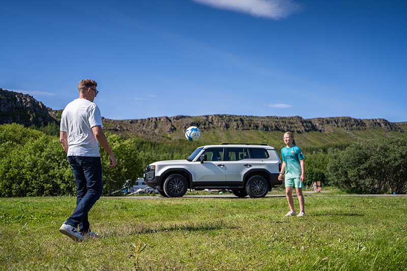 Father and daughter playing football on a self drive vacation in Iceland