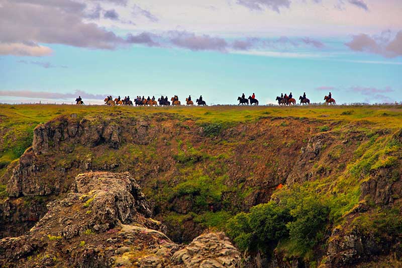 Horse riding tour passing Kolugljúfur in North Western Iceland
