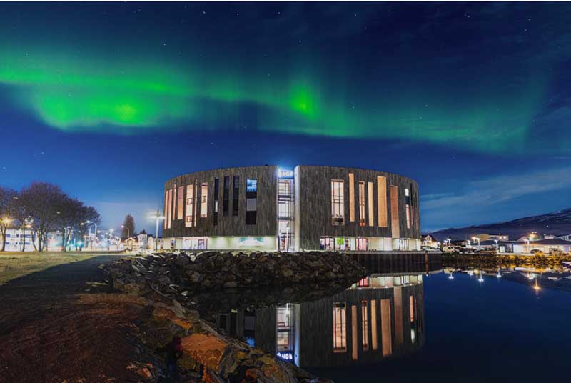 Aurora Borealis Dancing in the Sky Above the Beautiful Town of Akureyri in Northern Iceland