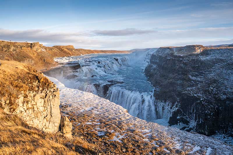 Gullfoss waterfall framed by late‑winter snow in Iceland