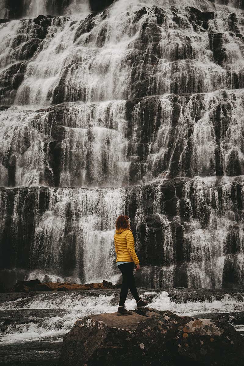 Woman eatching waterfall in Iceland