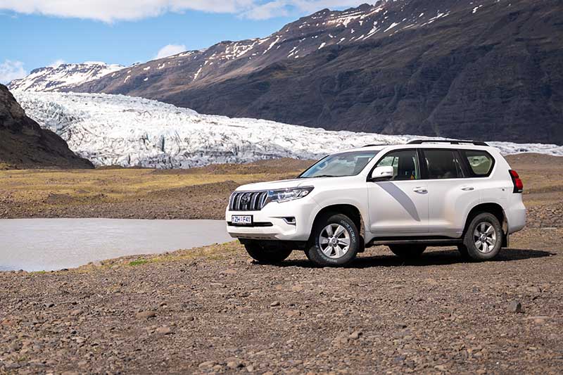 4x4 SUV from Holdur Car Rental parked at solheimajokull glacier lagoon